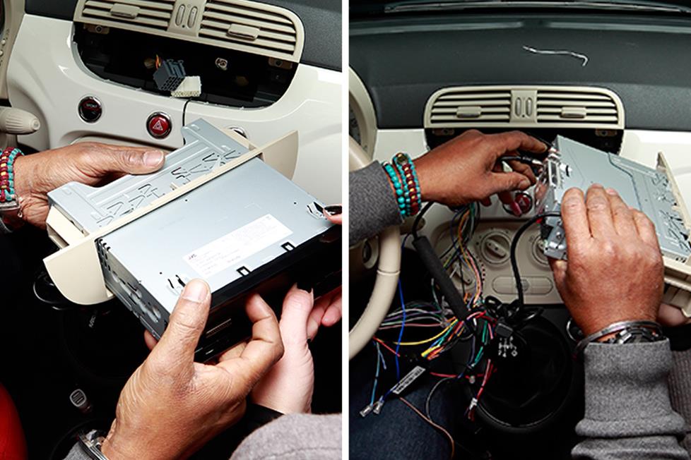 Nick, with some help from Angela, slid the JVC receiver inside the sleeve until it locked into place. He then plugged all the connections into the radio and locked the receiver and kit assembly into place.